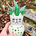 hand holding stained glass aloe plant in a cat pot Mountain Woman Products