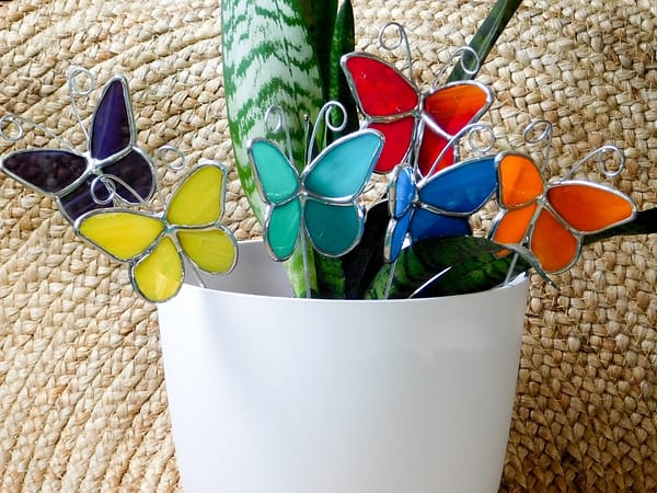 stained glass butterfly plant stakes in a snake plant Mountain Woman Products