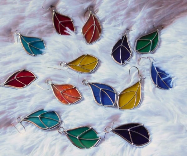 Stained Glass Peace leaf earrings lead free laying on furry surface Mountain Woman Products